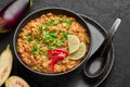 Baingan Bharta or Roasted Mashed Eggplant in black bowl on dark slate table top. Bhurta is indian cuisine puree dish Royalty Free Stock Photo