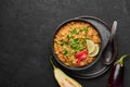 Baingan Bharta or Roasted Mashed Eggplant in black bowl on dark slate table top. Bhurta is indian cuisine puree dish Royalty Free Stock Photo