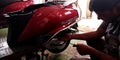 Bajaj automobile mechanic staff repairing motorcycle at service center in India aug 2019