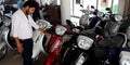 bajaj showroom salesmen touching latest Scotty bike at showroom in India