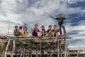 Bajau kids still on a wooden plank and showing hand gestures to tourist, Sabah Semporna, Malaysia