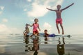 Bajau tribal kids having fun by jumping into sea from their boat, Sabah Semporna, Malaysia