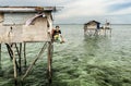 Bajau tribe mother sitting her wooden house in Sabah Semporna, Malaysia