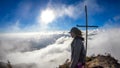 Bajawa - Girl standing on top of a volcano, surrounded by clouds Royalty Free Stock Photo