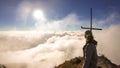 Bajawa - Girl standing on top of a volcano, surrounded by clouds