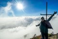 Bajawa - Girl standing on top of a volcano, surrounded by clouds