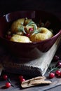 Baked apples, autumn or christmas winter dessert with cranberries, cinnamon, nuts and rosemary on dark moody background Royalty Free Stock Photo