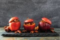 Baked apples with caramel, brown sugar and and nuts on a dark background Royalty Free Stock Photo