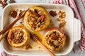 Baked apples with granola, cranberries, nuts and honey in oven dish Royalty Free Stock Photo