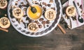 Baked apples with nuts and honey on a round baking tray on a wooden background, top view Royalty Free Stock Photo