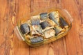 Baked Atlantic mackerel in glass casserole pan on old table Royalty Free Stock Photo