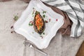 Baked aubergine stuffed with tomatoes and vegetables in sauce on the table Royalty Free Stock Photo