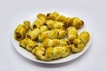 Baked ausages in the dough on a white plate against white background. Sausage Puff Pastry Buns.sausages wrapped in puff pastry and