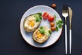 Backed avocado with egg and tomatoes on green background Royalty Free Stock Photo