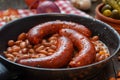 Baked beans with spicy pork sausages in frying pan Royalty Free Stock Photo