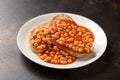 Baked beans on toast in tomato sauce on white plate Royalty Free Stock Photo