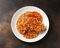 Baked beans on toast in tomato sauce on white plate Royalty Free Stock Photo