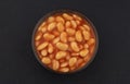 Baked beans in tomato sauce on black background, top view Royalty Free Stock Photo