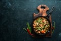 Baked beef with beans, tomatoes and vegetables in a frying pan. Top view. Royalty Free Stock Photo