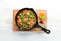 Baked beef with beans, tomatoes and vegetables in a frying pan. Top view. Royalty Free Stock Photo