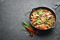 Baked beef with beans, tomatoes and vegetables in a frying pan. Top view. Royalty Free Stock Photo