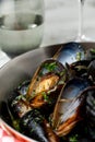 Baked blue mussels in spicy with lemon in a black cast-iron pot Royalty Free Stock Photo