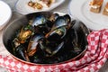 Baked blue mussels in spicy with lemon in a black cast-iron pot Royalty Free Stock Photo