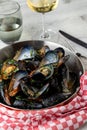 Baked blue mussels in spicy with lemon in a black cast-iron pot Royalty Free Stock Photo