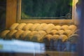 Baked bread in a bakery window display. Baked bread closeup in a typical confectionery shop