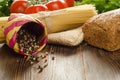 Baked bread with pasta, tomatos, greens and pepper on background