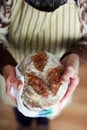Baked bread, whole-grain sourdough loaf holding hands