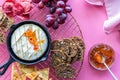 baked brie cheese in a cast iron skillet surrounded by assorted dippers.