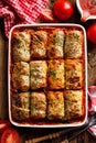 Baked cabbage rolls stuffed with groats and mushrooms in tomato sauce in a casserole dish Royalty Free Stock Photo