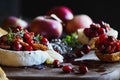 Baked Camembert Brie cheese with a cranberry honey and nut relish and apples Royalty Free Stock Photo