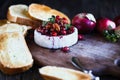 Whole baked Camembert Brie cheese with a cranberry honey and nut relish and apples Royalty Free Stock Photo