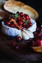 Baked Camembert Brie cheese with a cranberry honey and nut relish Royalty Free Stock Photo