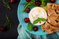 Baked Camembert cheese, toast and arugula salad with sweet cherries Royalty Free Stock Photo