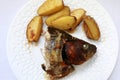 Baked carp head with potatoes