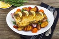 Baked carp with vegetables grilled on a white plate