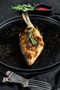 Baked carp on a white plate. River  organic fish. Black background. Top view. Space for text Royalty Free Stock Photo