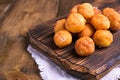 Baked castagnole with powdered sugar on wooden background. Street food, round biscuits with sugar for the carnival of