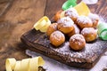 Baked castagnole with powdered sugar on wooden background. Street food, round biscuits with sugar for the carnival of