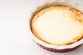 Baked cheesecake in ceramic cake pan on the table Royalty Free Stock Photo