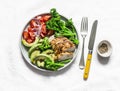 Baked chicken breast, broccoli, tomatoes, avocado salad on light background, top view. Balanced healthy eating buddha bowl