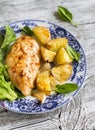 Baked chicken breast with potatoes and onions on a vintage plate Royalty Free Stock Photo