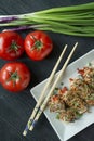 Baked chicken breast rolls with herbs, slices of carrots, bell pepper on a dark cutting board. Asian style. The balance of healthy Royalty Free Stock Photo