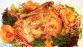 Baked chicken decorated with fresh vegetables.