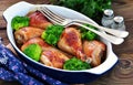 Baked chicken drumstick with organic broccoli on a wooden background. Royalty Free Stock Photo