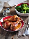 Baked chicken drumsticks with soy sauce, honey and grain mustard with boiled broccoli.