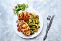 Fried chicken fillet. Broccoli and cauliflower. Baked chicken breast. Chicken and tomato. Food in a white plate on a light table Royalty Free Stock Photo